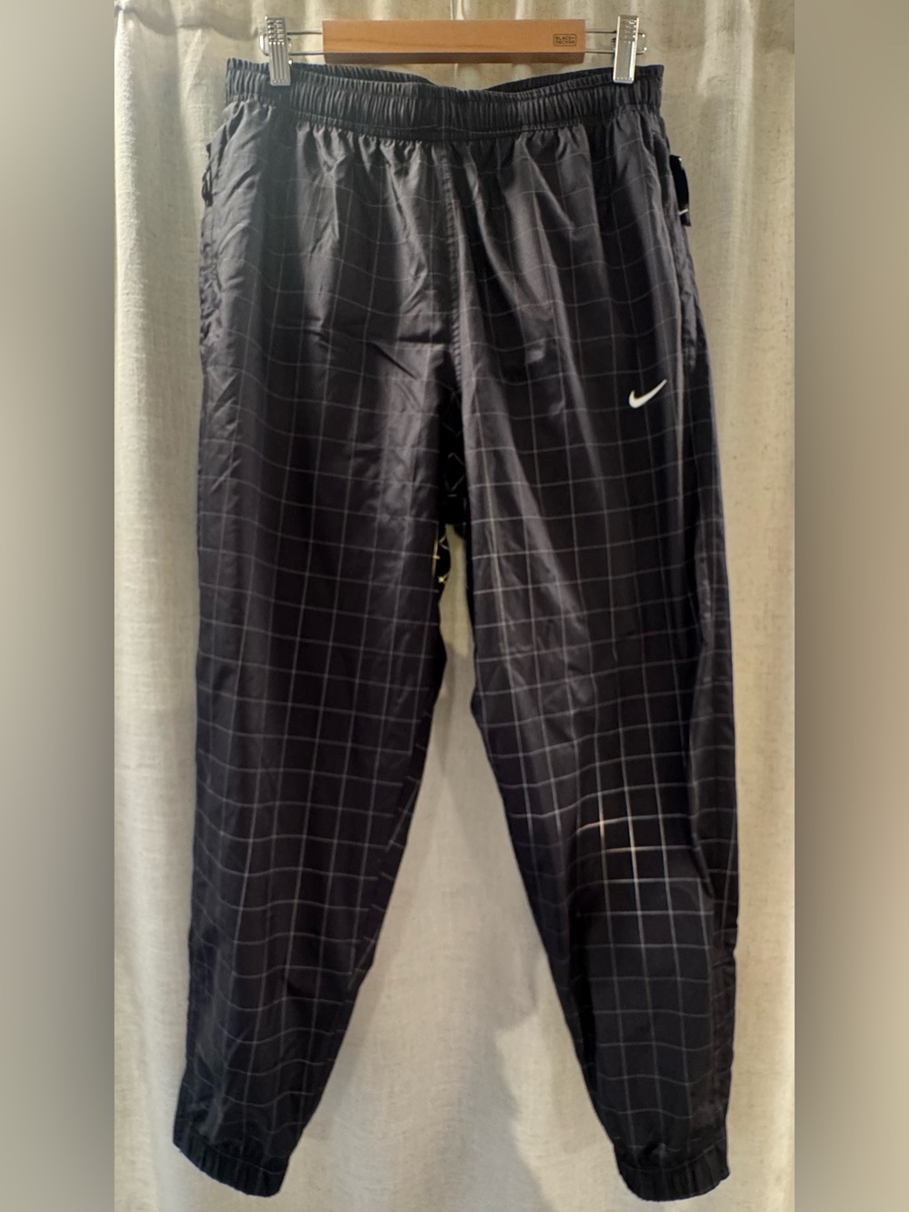 Nike Black Track Pants with White Swoosh and Grid Stitching